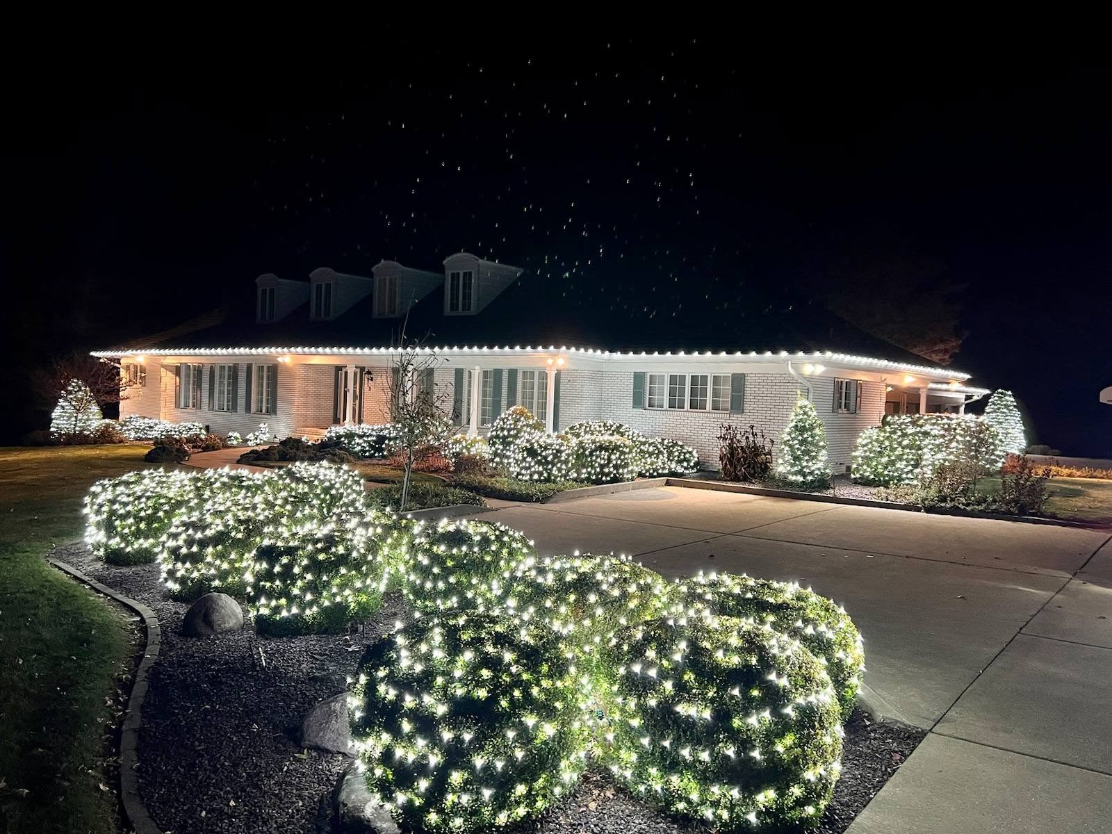 Elegant home with professionally installed warm white Christmas lights